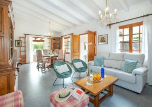 a living room with a couch and a table at Can Menonge by Vintage Travel in Pollença