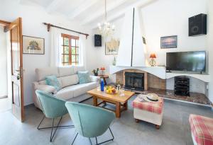 a living room with a couch and a fireplace at Can Menonge by Vintage Travel in Pollença