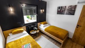 a small room with two beds and a window at KANIZSAY - Family&Wine House in Varaždinske Toplice +46 photos