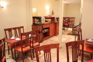 a dining room with tables and chairs and a microwave at Metropol in Paris