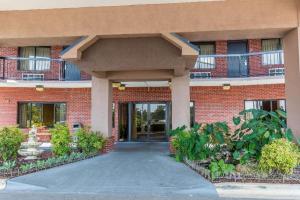 a red brick building with a door in front at Quality Inn Calera I-65 exit 231 in Calera
