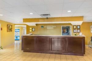 a lobby with a large brown counter in a hospital at Quality Inn Calera I-65 exit 231 in Calera +47 photos