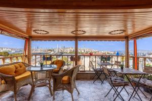 a patio with tables and chairs and a view of the city at The Astra Hotel in Istanbul