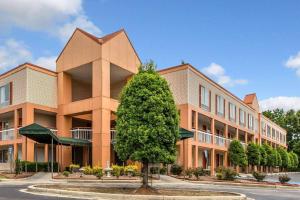 a large building with a tree in front of it at Quality Inn Homewood Birmingham I-65 in Birmingham