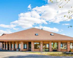 a large brick building with a sky in the background at Quality Inn & Suites Kimberly - Appleton East in Kimberly