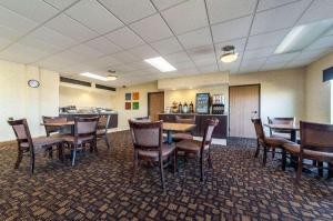 a dining room with tables and chairs and a bar at Quality Inn in Clarksdale