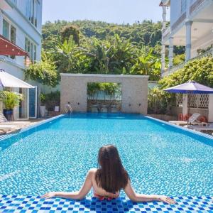 a woman laying on the floor of a swimming pool at Sea Mountain Hotel in Vung Tau