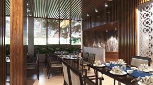 a dining room with tables and chairs and windows at Sea Mountain Hotel in Vung Tau