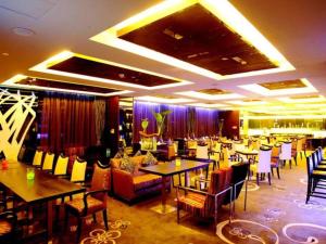 a restaurant with tables and chairs in a room at Grand View Hotel Tianjin in Tianjin