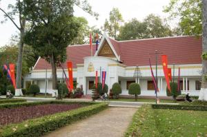 a building with a red roof with flags in front of it at Sokhalay Angkor Residence and Spa in Siem Reap