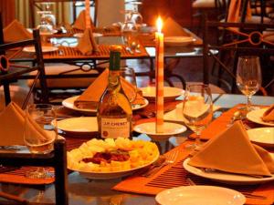 a table with plates of food and a bottle of wine at The Hideaway Hotel in Ella