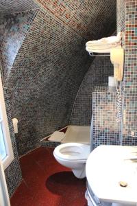 a bathroom with a toilet and a sink at Metropol in Paris