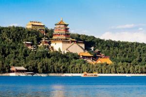 a large building on a hill next to a body of water at Hanting Hotel Beijing Summer Palace Branch in Beijing