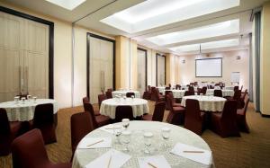 a conference room with tables and chairs and a screen at Cipta Hotel Pancoran in Jakarta +113 photos