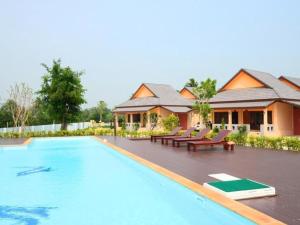 a resort with a swimming pool and a house at Juntima Boutique Hotel in Ban Rong Rakam