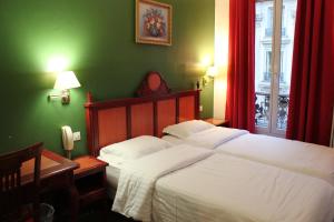 a bedroom with a large bed in a green room at Metropol in Paris