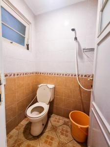 ein Badezimmer mit Toilette und Dusche in der Unterkunft Villa Pesona Merapi With 3 BR in Ngaglik + 7 Fotos