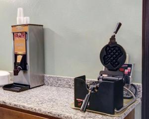 a kitchen counter with a iron and a coffee maker at Quality Inn & Suites Airport in Austin