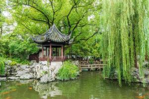 a pagoda in a garden next to a pond at Jinjiang Inn Select Shanghai Nanjing Road Pedestrian Street in Shanghai