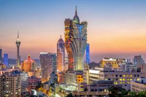 a city skyline at night with a tall building at StarWorld Hotel in Macau