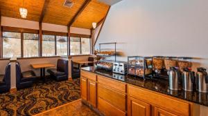 a restaurant with a counter with food on it at Best Western Lake Lucille Inn in Wasilla