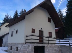a large white building with a wooden roof at Holiday Home Stevas in Žabljak