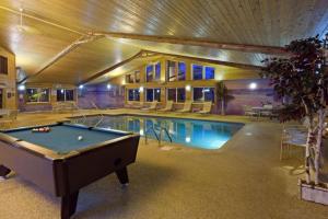 a pool table in front of a swimming pool at AmericInn by Wyndham Pequot Lakes in Pequot Lakes +46 photos