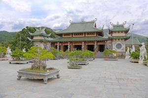 a large building with trees in front of it at SPOT ON 1115 Romantic Motel in Da Nang