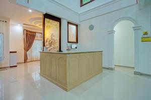 a large room with a counter in a building at OYO 92990 Nena Kostel Syariah in Padang