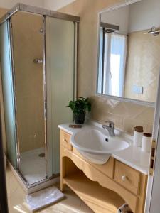 a bathroom with a sink and a shower at Lotus Country House in Crespellano