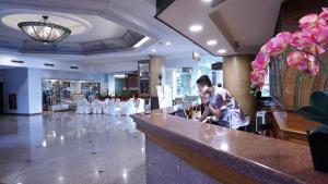 a man standing at a bar in a restaurant at Kedaton Hotel in Bandung +200 photos