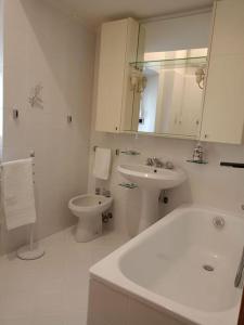 a white bathroom with a sink and a toilet at Meihome-Genova in Genova