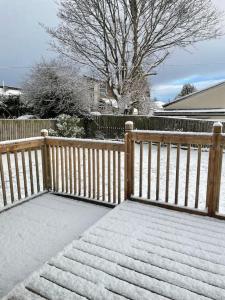 a wooden fence with snow on the ground at 3 bedroom detached house, close to Glasgow in Barrhead