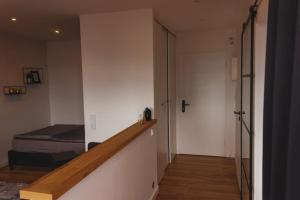a bedroom with a bed and a stairway with a door at Apartment Deich 136 in Bremerhaven