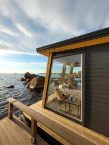 a house on a dock with a large window at Mökkilautta in Kalajoki +5 photos