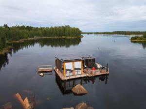 a small house on a dock on a lake at Mökkilautta in Kalajoki