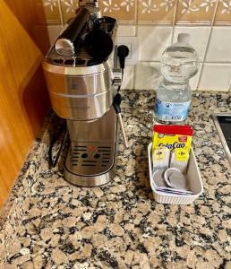 a coffee maker on a counter with a bottle of water at Sol & Mar in El Médano