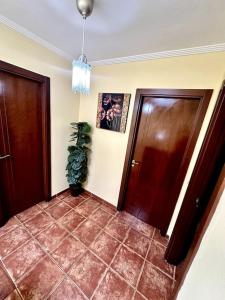 a hallway with two doors and a potted plant at Sol & Mar in El Médano