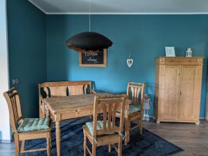 a dining room with a wooden table and chairs at Ferienwohnung zum Hühnerstall in Förbau
