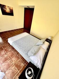 a small bedroom with a bed in a room at Sol & Mar in El Médano +20 photos