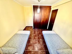 a hallway with two beds in a room with a door at Sol & Mar in El Médano