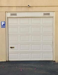 a white garage door on the side of a building at Sol & Mar in El Médano