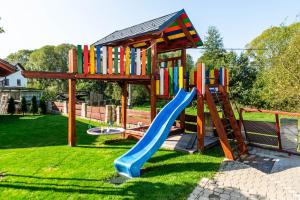 a playground with a slide and a play structure at Apartmán na okraji města s vlastním parkováním in Česká Lípa
