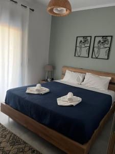 a bedroom with a bed with two towels on it at La casa in Chios