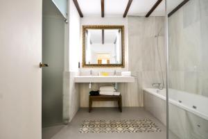 a bathroom with a sink and a mirror at Legado Alcazar Hotel in Seville +114 photos