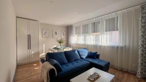 a living room with a blue couch and a table at Heron in Tychy