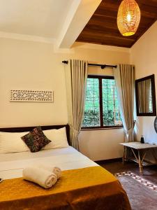 a bedroom with a bed and a window at Kandy Living Homestay in Kandy +39 photos