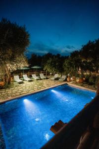 a large blue swimming pool with lounge chairs next to it at Casale del Nonno in Sorrento
