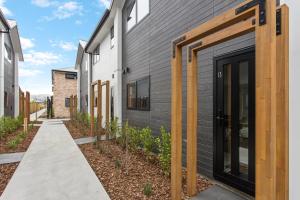 a house with wooden doors on the side of it at Prime Location Cosy Warm Free Off Street Park in Addington