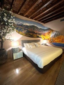 a bedroom with a bed with a painting on the wall at Gar Anat Hotel Boutique in Granada